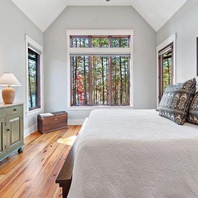 Primary bedroom with woodland views in an Asheville area vacation rental.