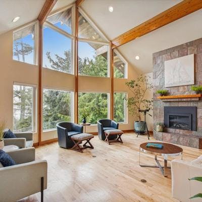 Living room with huge windows and fireplace