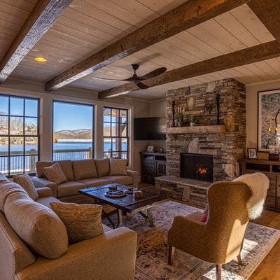 Living room with a fireplace and lake views.