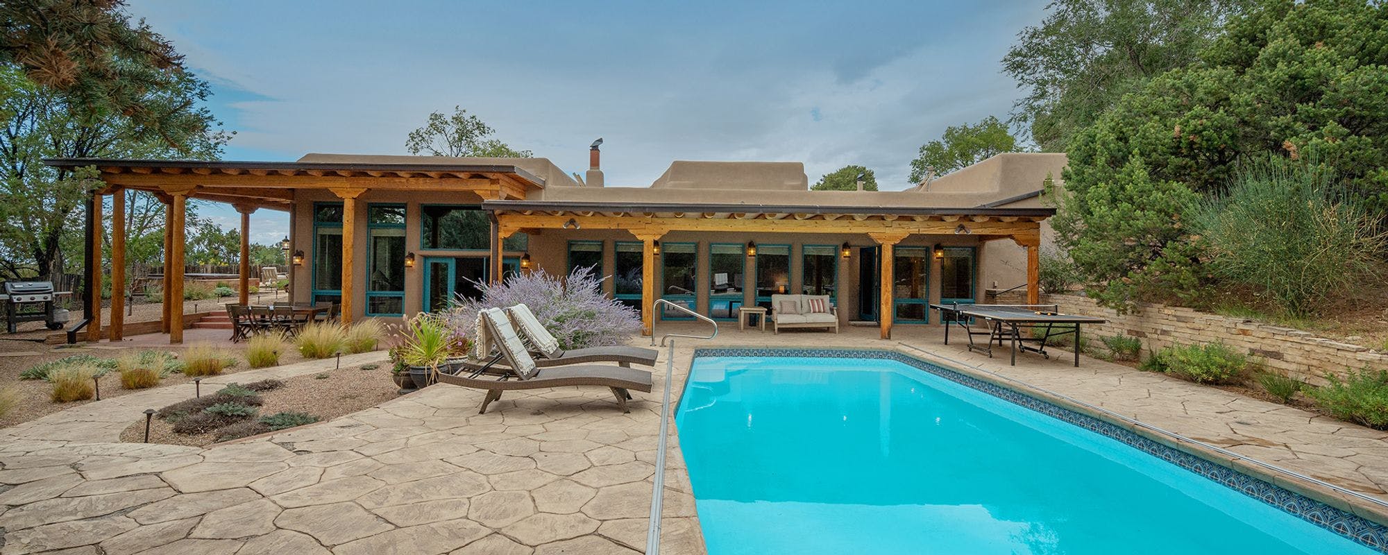 Luxurious outdoor living space with a pool at a Santa Fe vacation rental