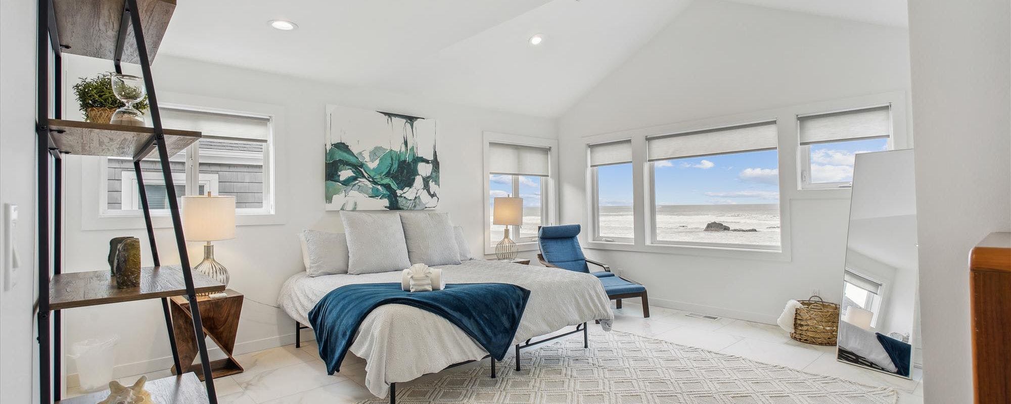 Bedroom with oceanfront views by Beachcomber Vacation Homes