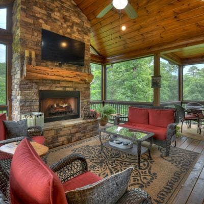 Expansive screened porch with a fireplace at a Blue Ridge cabin rental.
